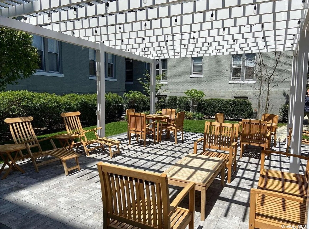 a view of a patio with table and chairs with wooden floor and fence