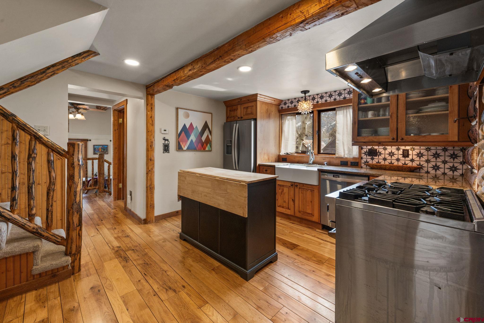 31 Gothic Avenue Crested Butte, CO 81224 - Photo 9 of 33 a kitchen with stainless steel appliances granite countertop a stove and a refrigerator
