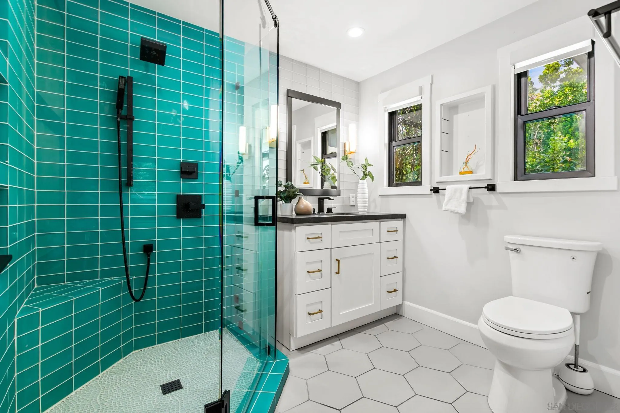 2335 Ivy Road Oceanside, CA 92054 - Photo 28 of 53 a bathroom with a granite countertop sink a toilet and shower