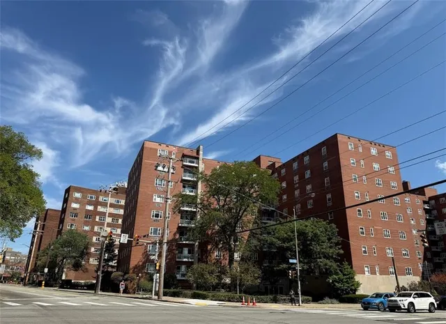a view of a tall building next to a road