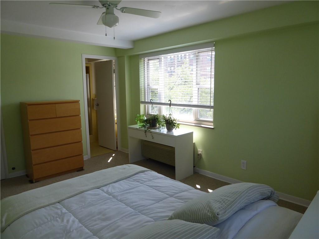 4601 Fifth Avenue, Unit 623 Pittsburgh, PA 15213 - Photo 18 of 28 a bedroom with a bed and a dresser