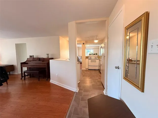 a living room with furniture and a piano table