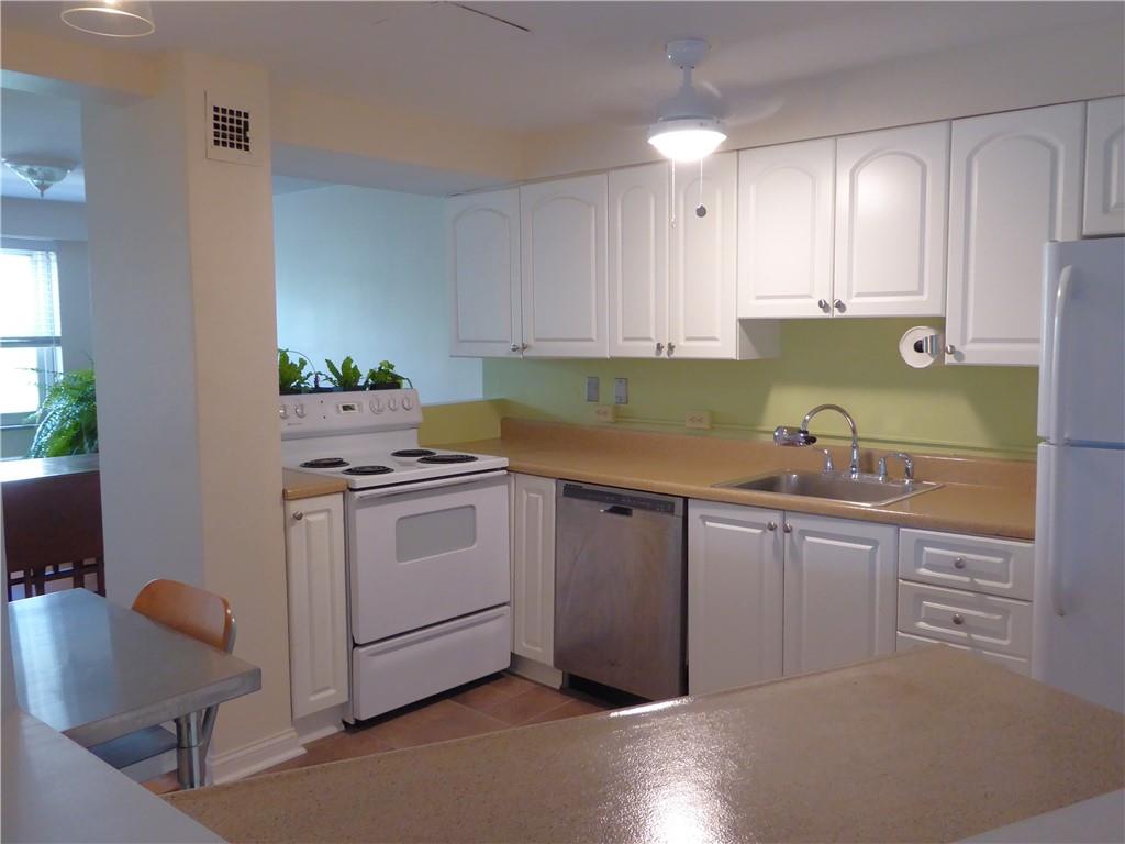 4601 Fifth Avenue, Unit 623 Pittsburgh, PA 15213 - Photo 10 of 28 a kitchen with granite countertop white cabinets and white appliances
