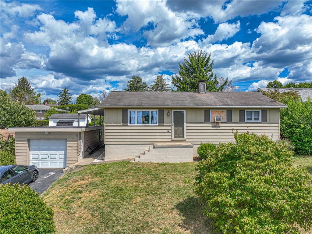 a front view of house with yard and trees around