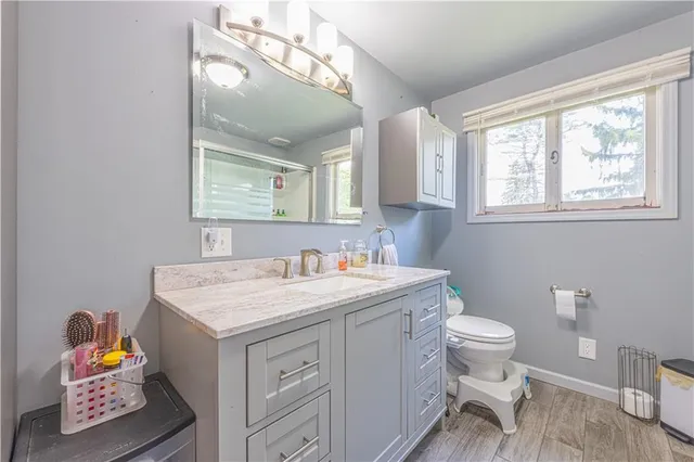 a bathroom with a sink toilet and mirror