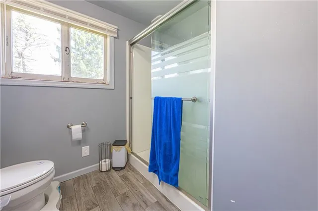 a bathroom with a toilet and a shower