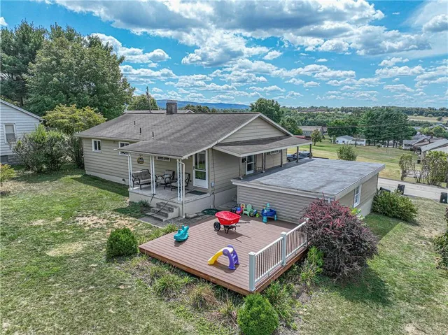 an aerial view of a house with table and chairs