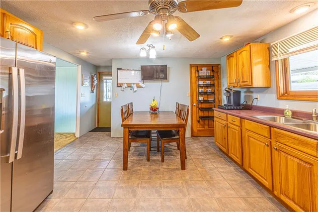 a large kitchen with a table and chairs in it