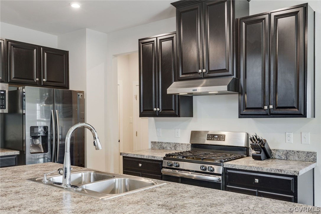 10419 Centralia Station Chester, VA 23831 - Photo 21 of 50 a kitchen with stainless steel appliances granite countertop a refrigerator a stove and a sink with wooden floor