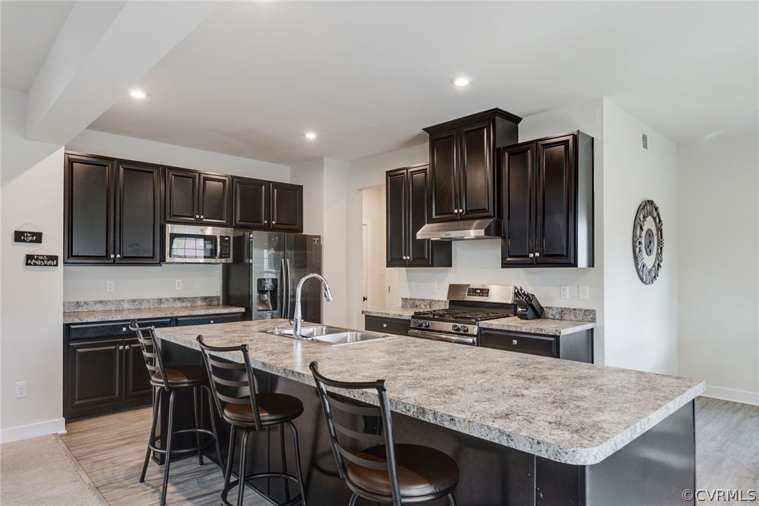 10419 Centralia Station Chester, VA 23831 - Photo 22 of 50 a kitchen with stainless steel appliances granite countertop a stove a sink a microwave a refrigerator and chairs