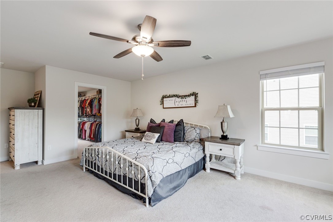 10419 Centralia Station Chester, VA 23831 - Photo 32 of 50 a bedroom with a bed chandelier and a window