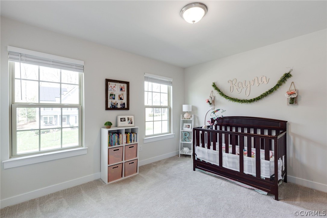 10419 Centralia Station Chester, VA 23831 - Photo 36 of 50 a living room with a baby crib furniture a window and a chandelier