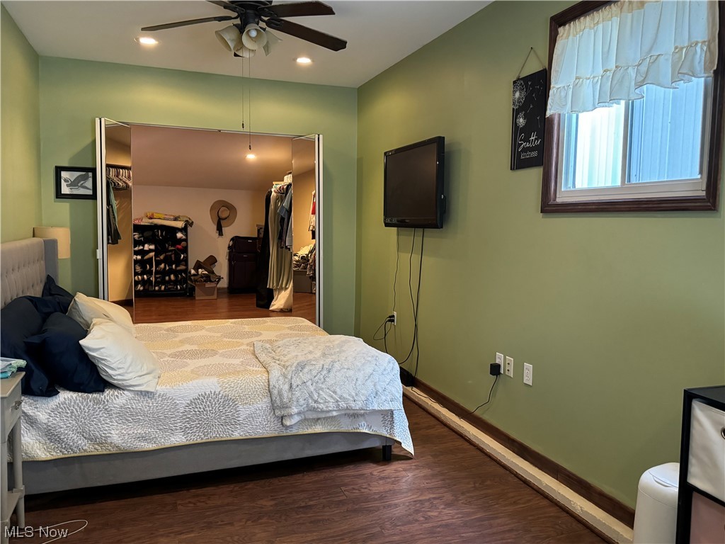 125 Sundale Road Norwich, OH 43767 - Photo 13 of 18 Bedroom with a spacious closet, dark wood-type flooring, ceiling fan, and a closet