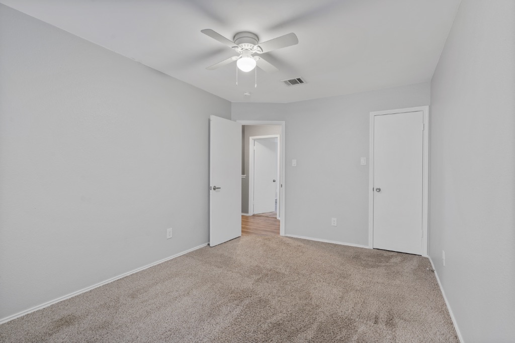 911 Flatters Way Pflugerville, TX 78660 - Photo 21 of 31 a view of an empty room with a ceiling fan