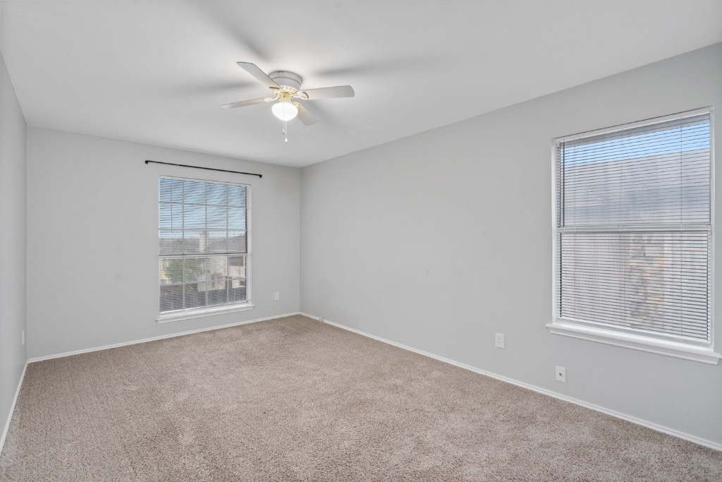 911 Flatters Way Pflugerville, TX 78660 - Photo 26 of 31 an empty room with windows and fan