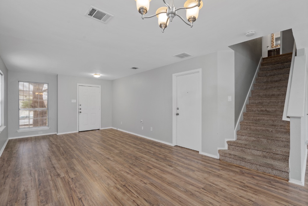 911 Flatters Way Pflugerville, TX 78660 - Photo 5 of 31 a view of empty room with wooden floor and fan