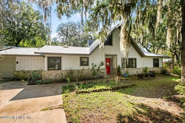 a front view of house with yard and green space