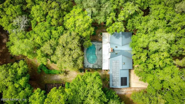 an aerial view of a house with a yard