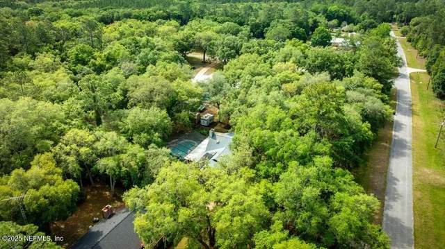 a view of a lush green forest with houses