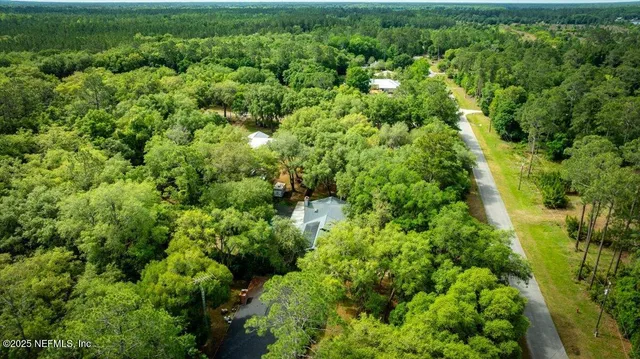 a view of a green yard with a lake
