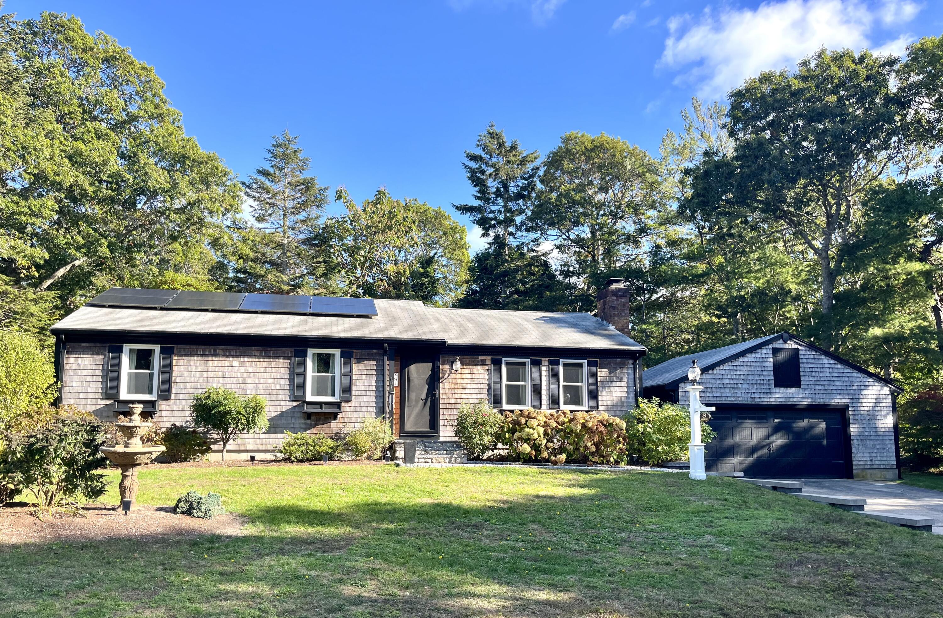 a front view of a house with a garden