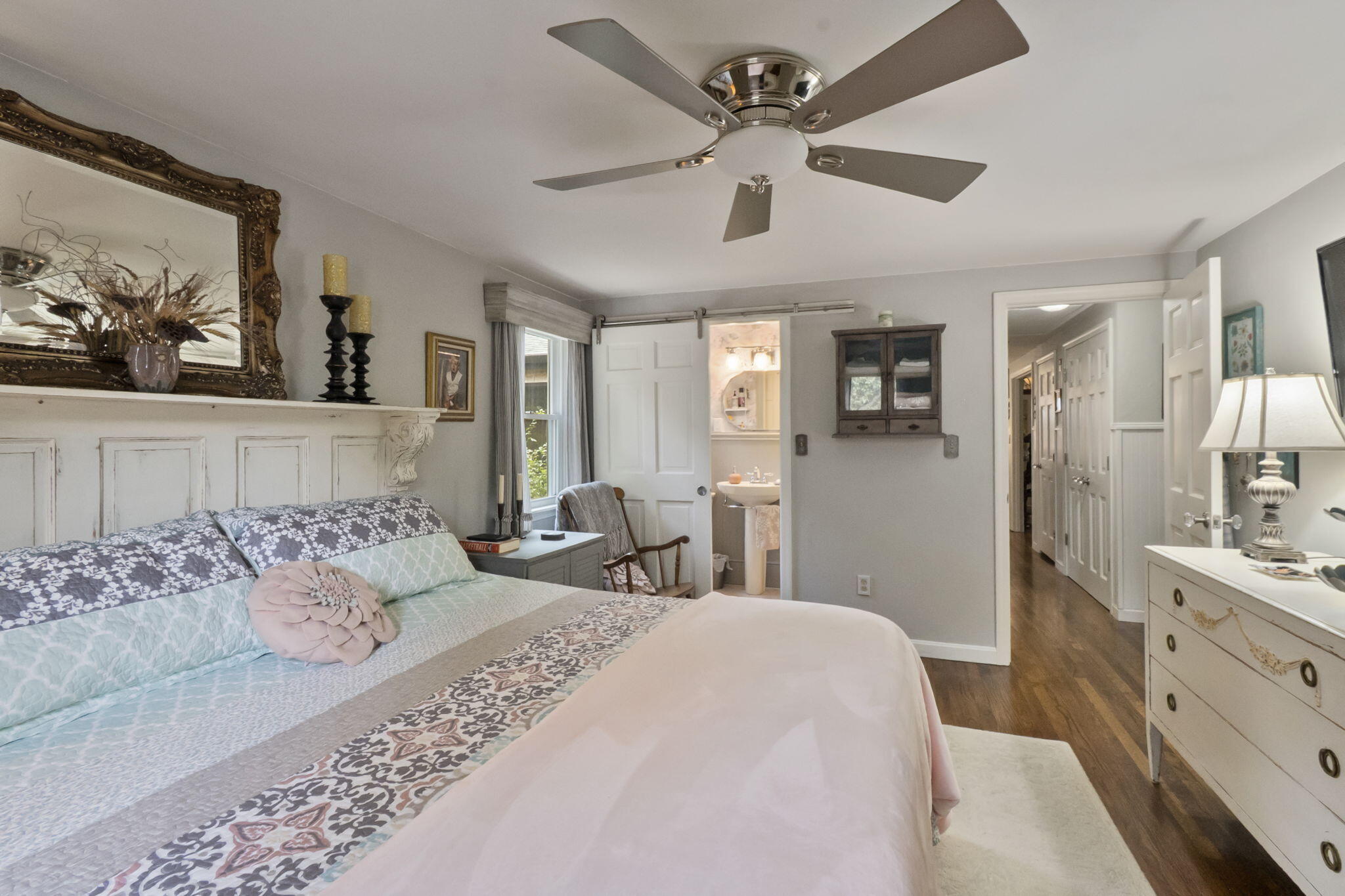 8 Jib Way Hyannis, MA 02601 - Photo 20 of 40 a bedroom with a large bed and a chandelier