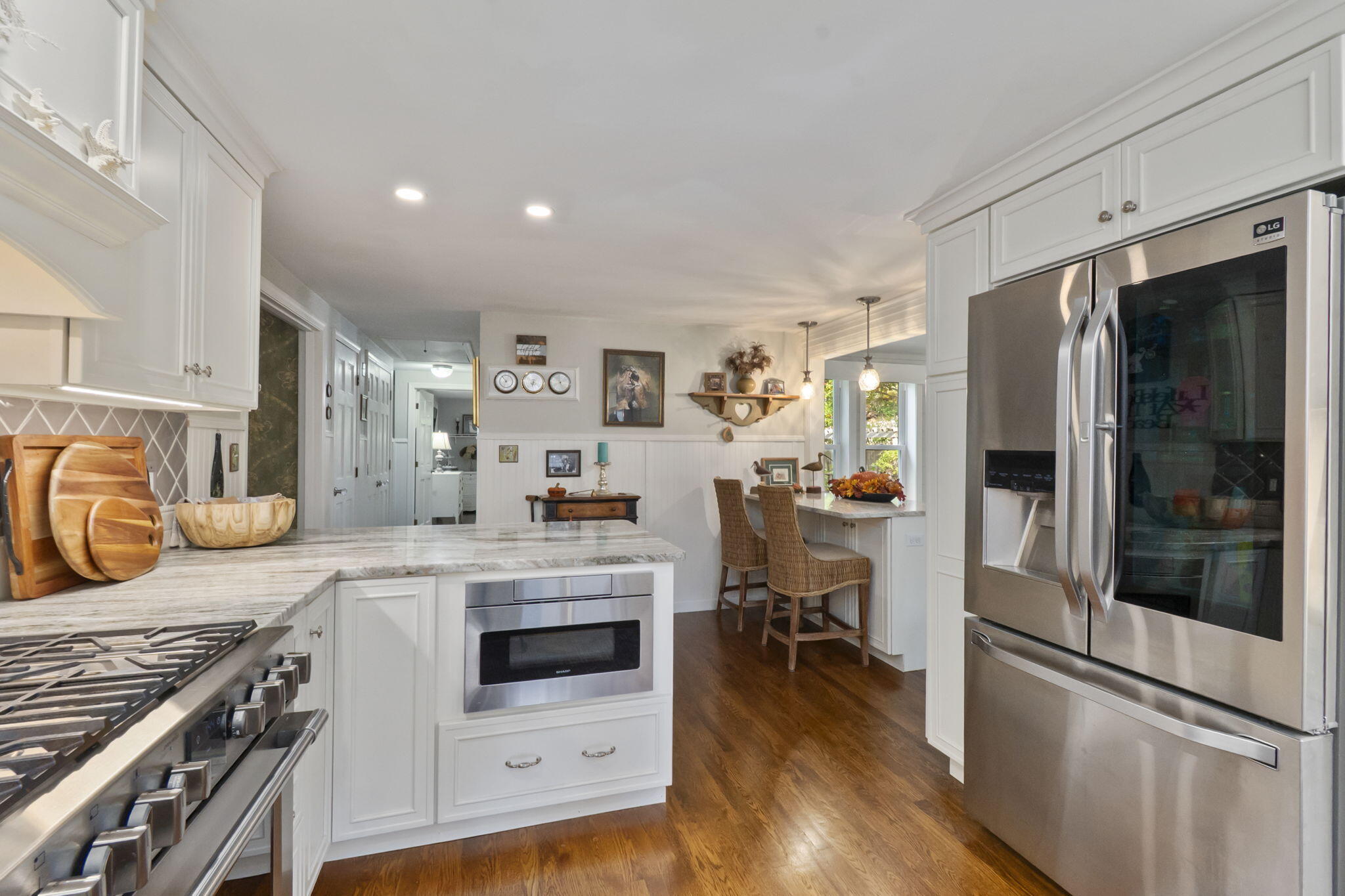 8 Jib Way Hyannis, MA 02601 - Photo 9 of 40 a kitchen with stainless steel appliances a stove a sink dishwasher a refrigerator and cabinets with wooden floor