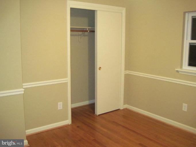 3409 Reedy Drive Annandale, VA 22003 - Photo 17 of 30 an empty room with wooden floor and windows