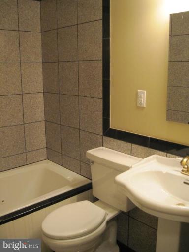 3409 Reedy Drive Annandale, VA 22003 - Photo 19 of 30 a bathroom with a sink a toilet and shower