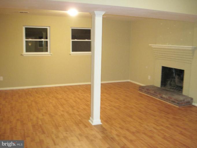 3409 Reedy Drive Annandale, VA 22003 - Photo 21 of 30 a view of an empty room with wooden floor and a fireplace