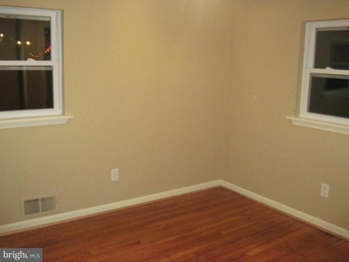 3409 Reedy Drive Annandale, VA 22003 - Photo 26 of 30 an empty room with wooden floor and fan