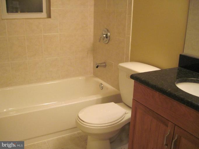 3409 Reedy Drive Annandale, VA 22003 - Photo 27 of 30 a bathroom with a granite countertop toilet sink and shower