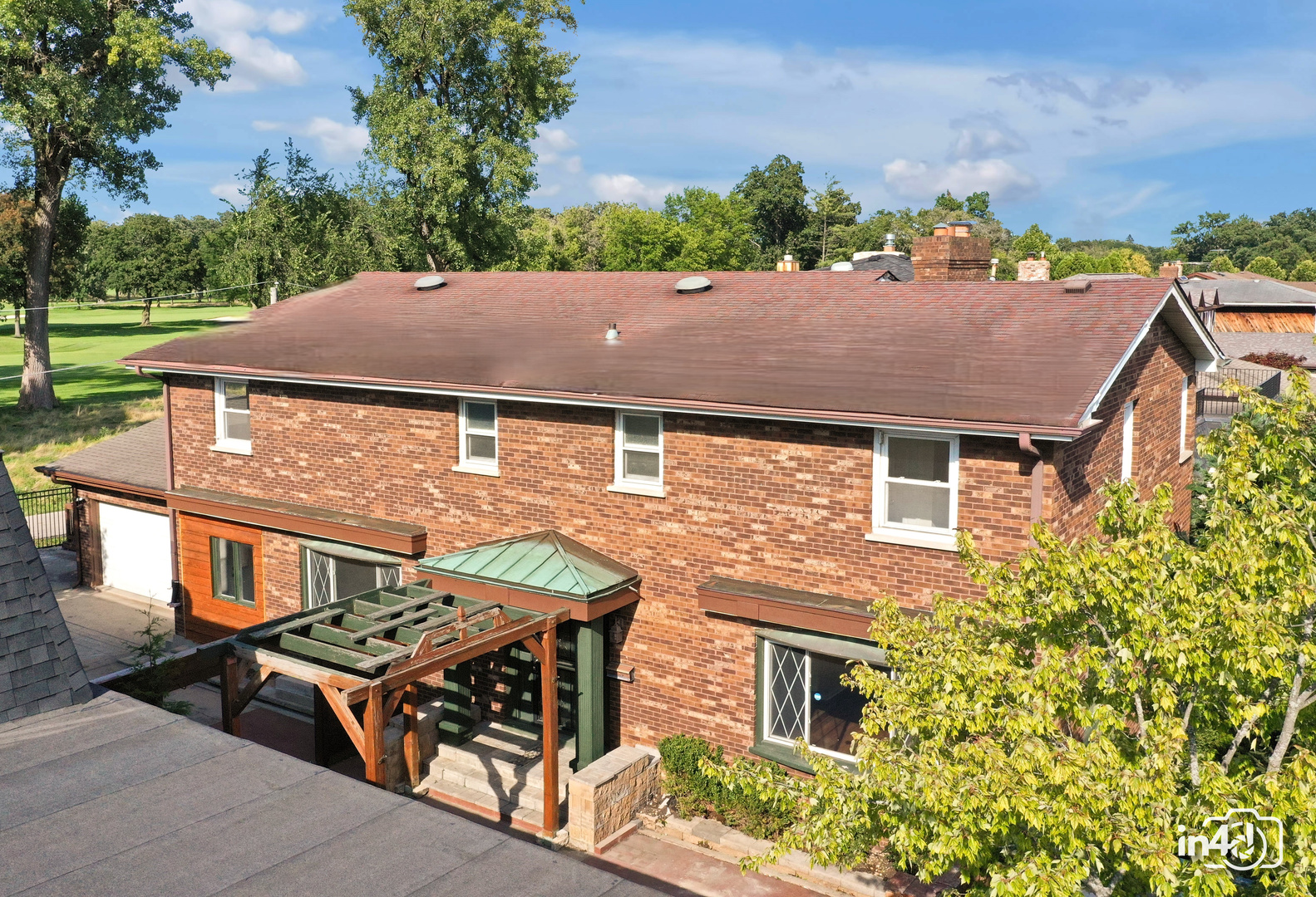 an aerial view of a house with a yard and table and chairs