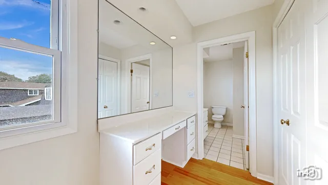 a view of bathroom with a sink toilet and a window