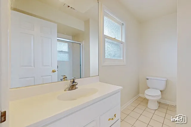 a bathroom with a sink toilet and vanity