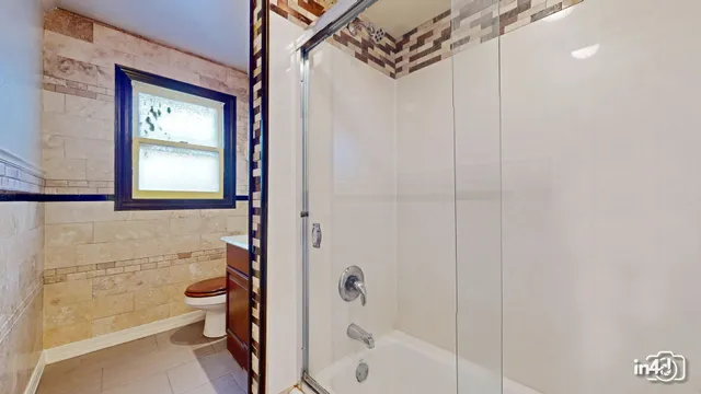 a bathroom with a granite countertop sink a toilet and a mirror