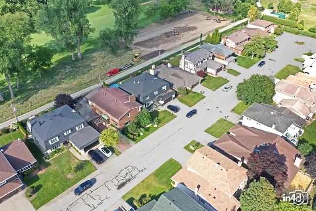 an aerial view of a house with a yard and a patio