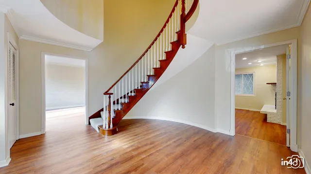 a view of entryway with wooden floor and stairs