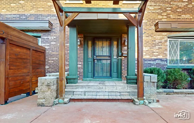 a view of a patio with a table and chairs under an umbrella