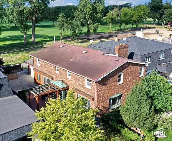 an aerial view of a house with a yard table and chairs