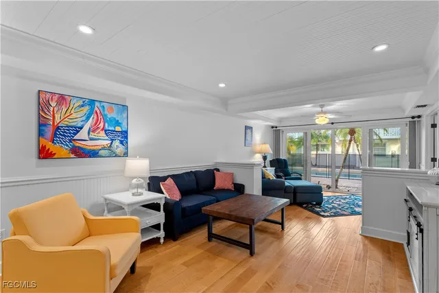 a living room with furniture a couch and a large window