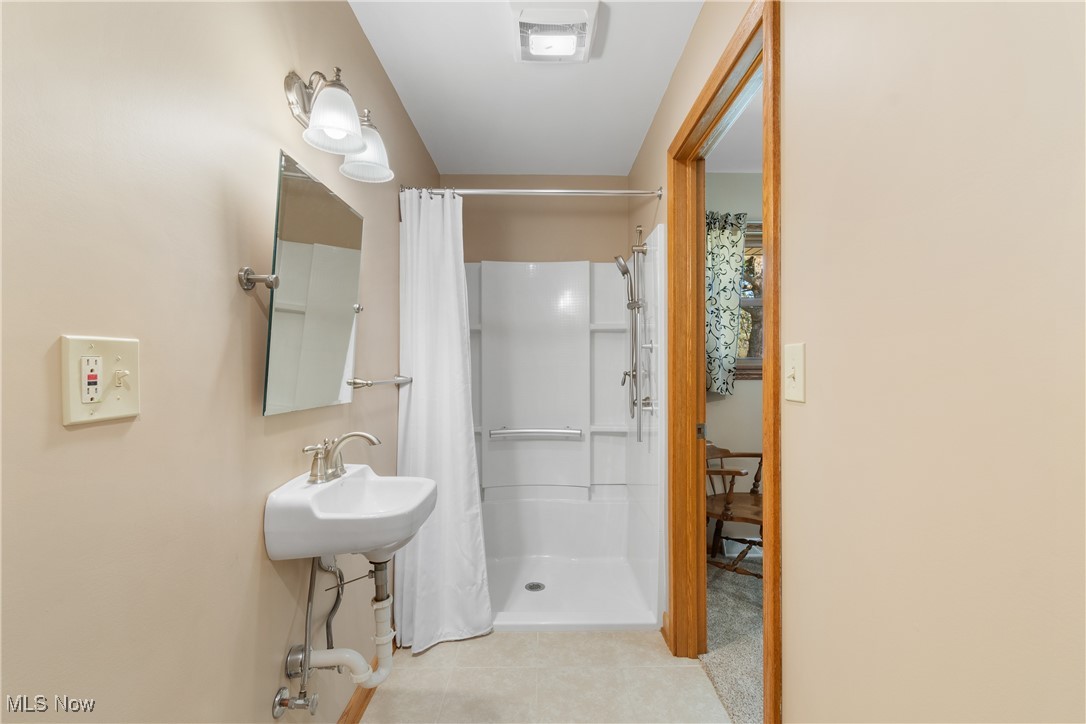 3240 Copley Road Akron, OH 44321 - Photo 17 of 35 Bathroom featuring sink and curtained shower