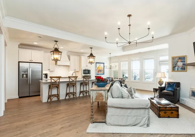 a living room with furniture and kitchen view