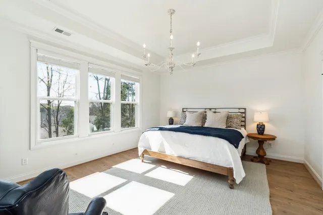 a spacious bedroom with a bed and a window