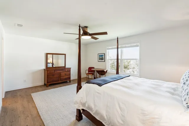 a bedroom with a bed and a large window