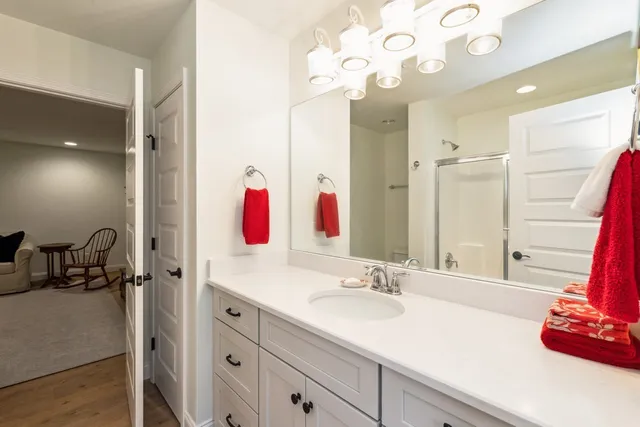 a bathroom with a sink vanity tub and a mirror