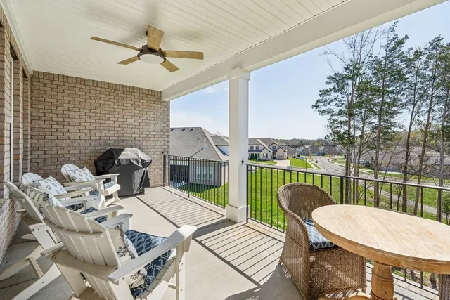 a balcony with a table and chairs