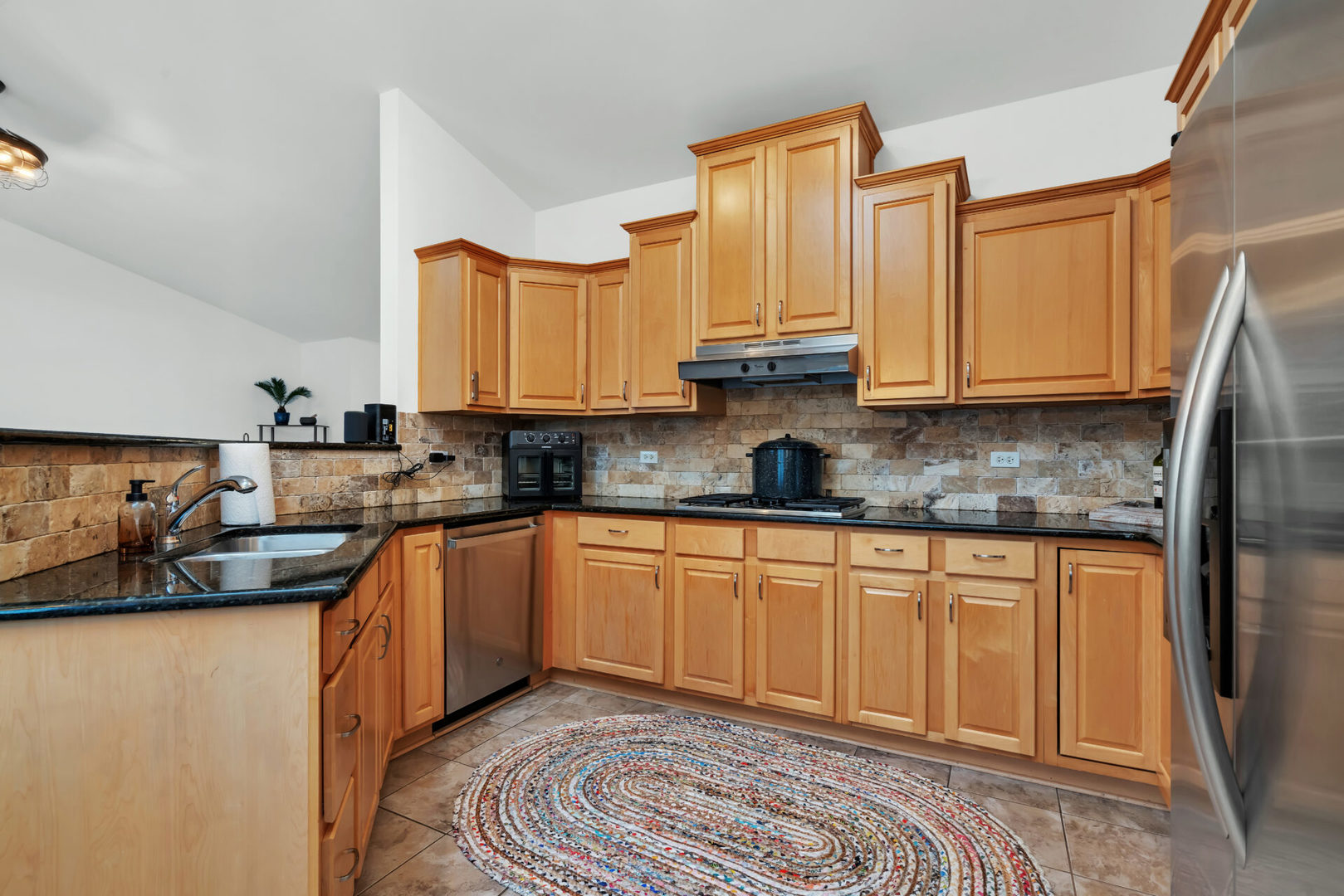 13265 Forest Ridge Drive Palos Heights, IL 60463 - Photo 6 of 12 a kitchen with stainless steel appliances granite countertop a sink stove and cabinets
