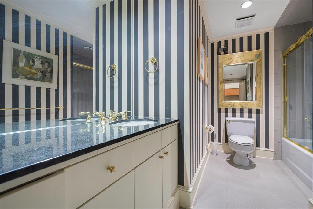 5200 Keller Springs Road, Unit 1534/36 Dallas, TX 75248 - Photo 28 of 35 a bathroom with a granite countertop sink a toilet and a window