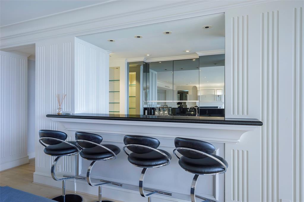 5200 Keller Springs Road, Unit 1534/36 Dallas, TX 75248 - Photo 10 of 35 a kitchen with a cabinets and chairs in it